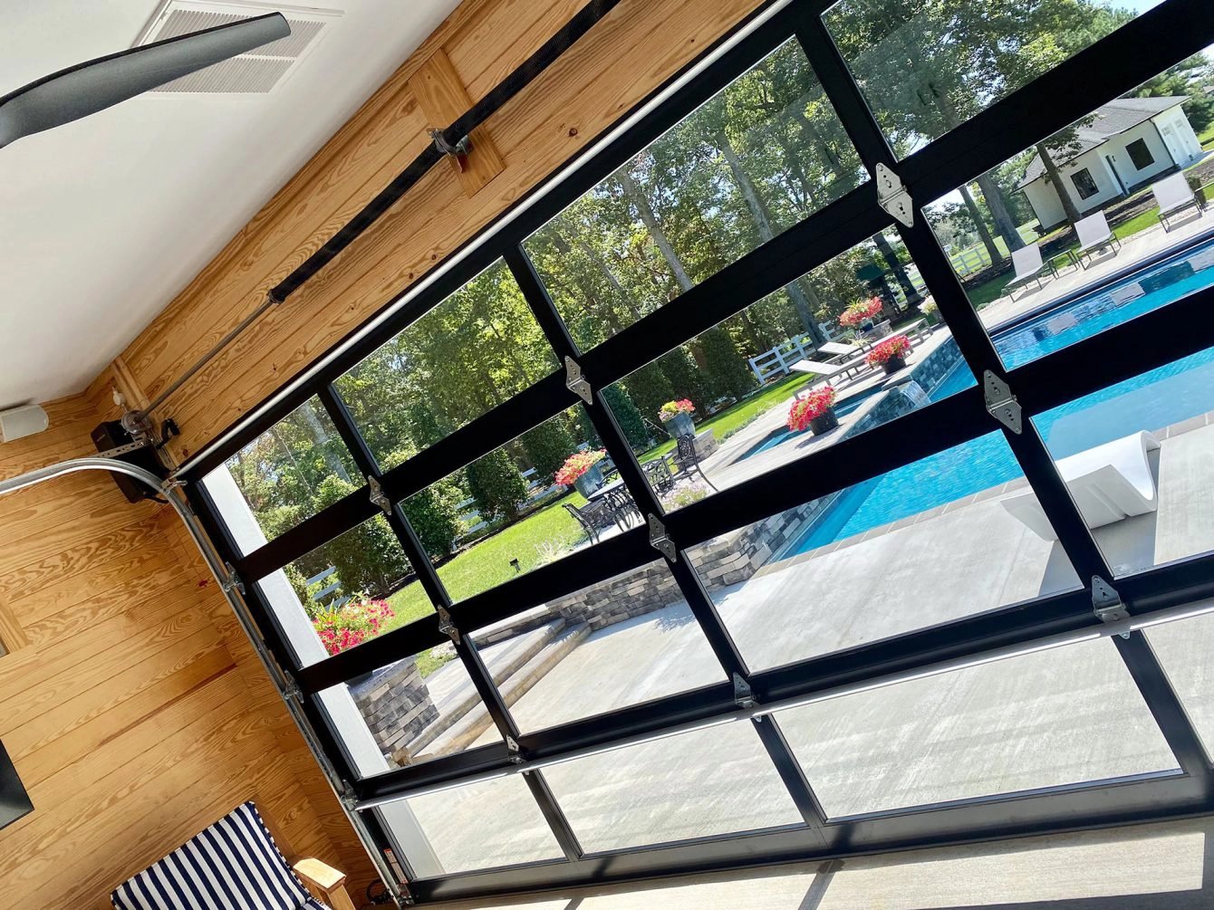 Clear Garage Door Looking Out at Pool 